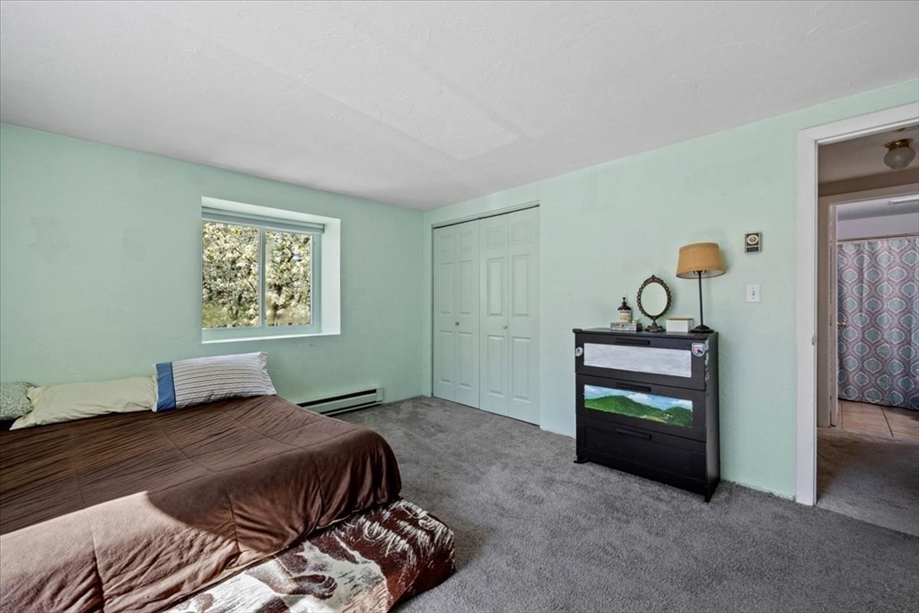 20 Erick Road, Unit 18 Mansfield, MA 02048 - Photo 12 of 21 a bedroom with a bed and a table