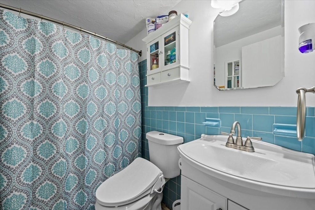 20 Erick Road, Unit 18 Mansfield, MA 02048 - Photo 14 of 21 a bathroom with a sink a toilet and a mirror