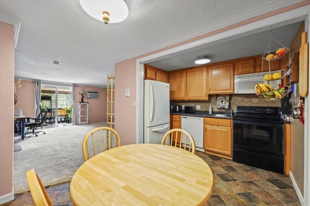 20 Erick Road, Unit 18 Mansfield, MA 02048 - Photo 7 of 21 a kitchen with stainless steel appliances granite countertop a stove refrigerator and cabinets