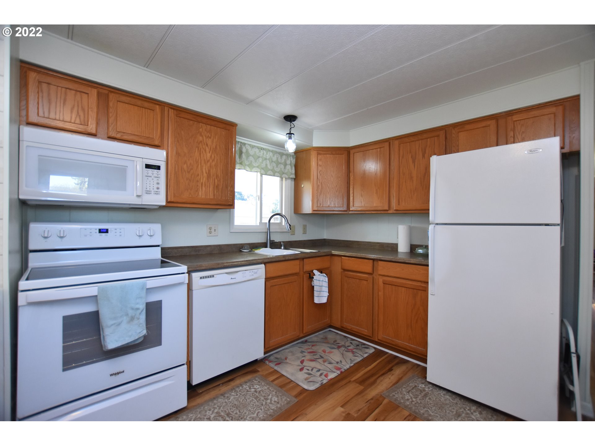2150 Laura Street, Unit 26 Springfield, OR 97477 - Photo 13 of 26 a kitchen with stainless steel appliances granite countertop a refrigerator sink and cabinets