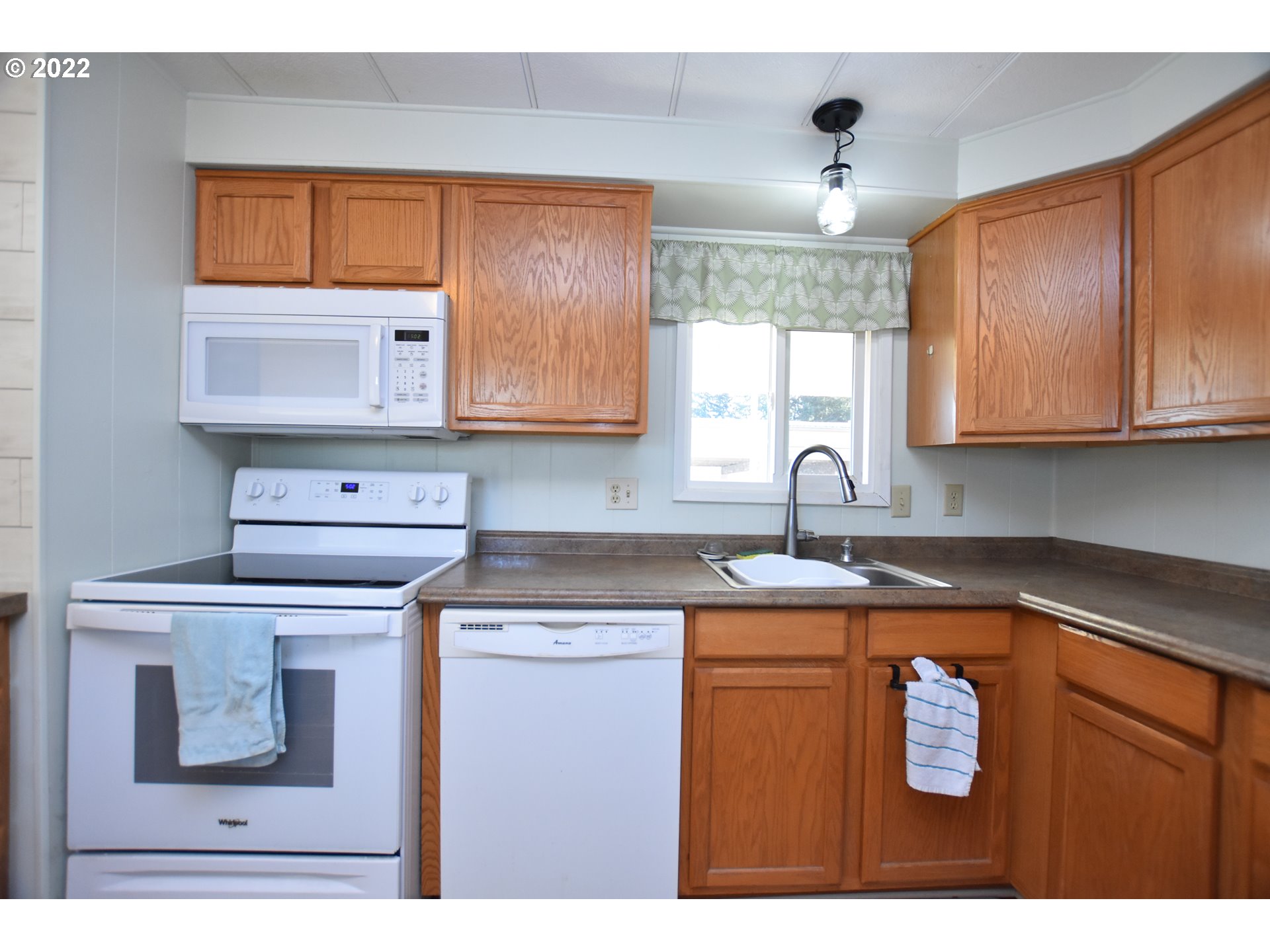 2150 Laura Street, Unit 26 Springfield, OR 97477 - Photo 14 of 26 a kitchen with stainless steel appliances granite countertop a sink a stove and microwave