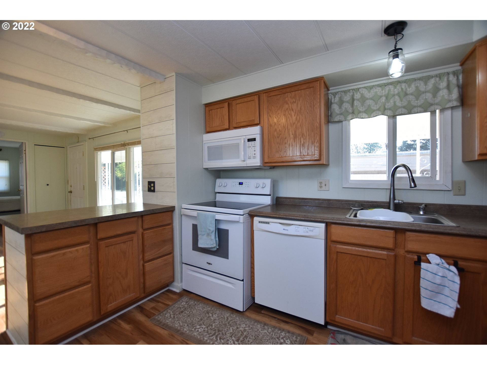 2150 Laura Street, Unit 26 Springfield, OR 97477 - Photo 15 of 26 a kitchen with stainless steel appliances granite countertop a sink stove and cabinets