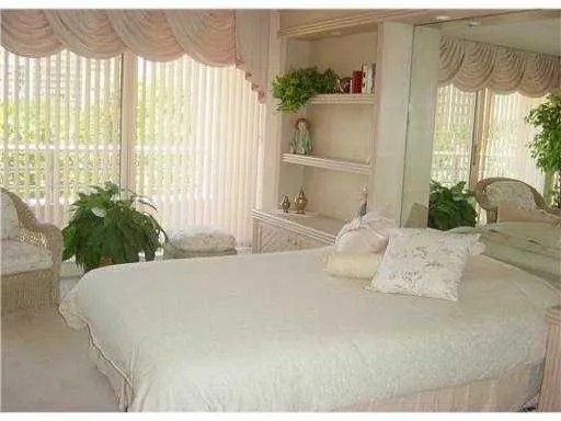 a bedroom with a large bed and a large window