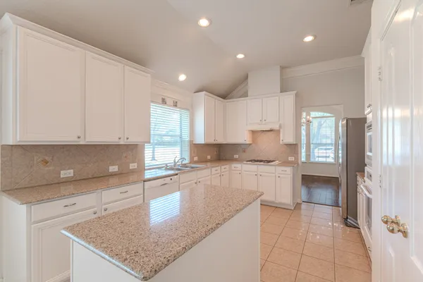 a view of a livingroom with a fireplace a chandelier and wooden floor