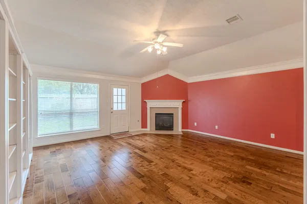 a view of a livingroom with a ceiling fan and window