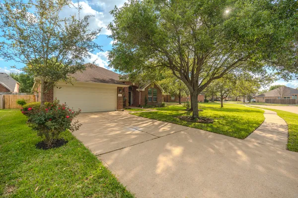 a front view of house with yard and green space