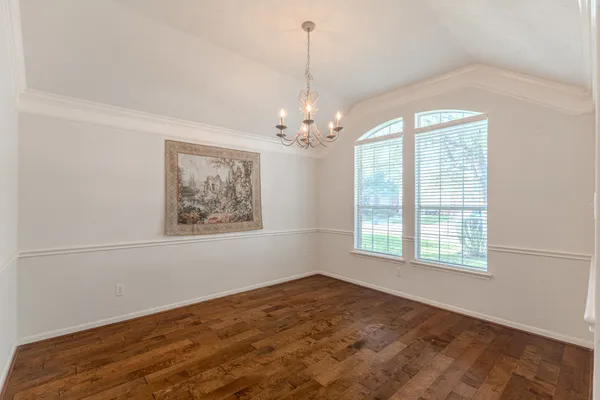 a room with a desk and wooden floor