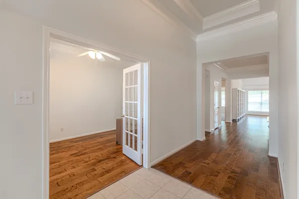 a large kitchen with a lot of white cabinets and stainless steel appliances