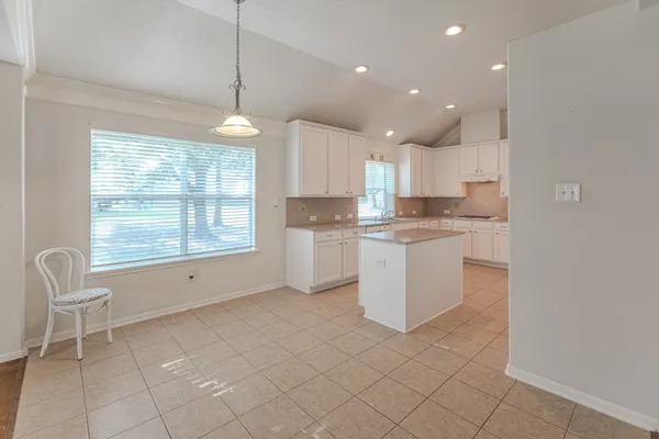 a kitchen with a sink appliances and cabinets