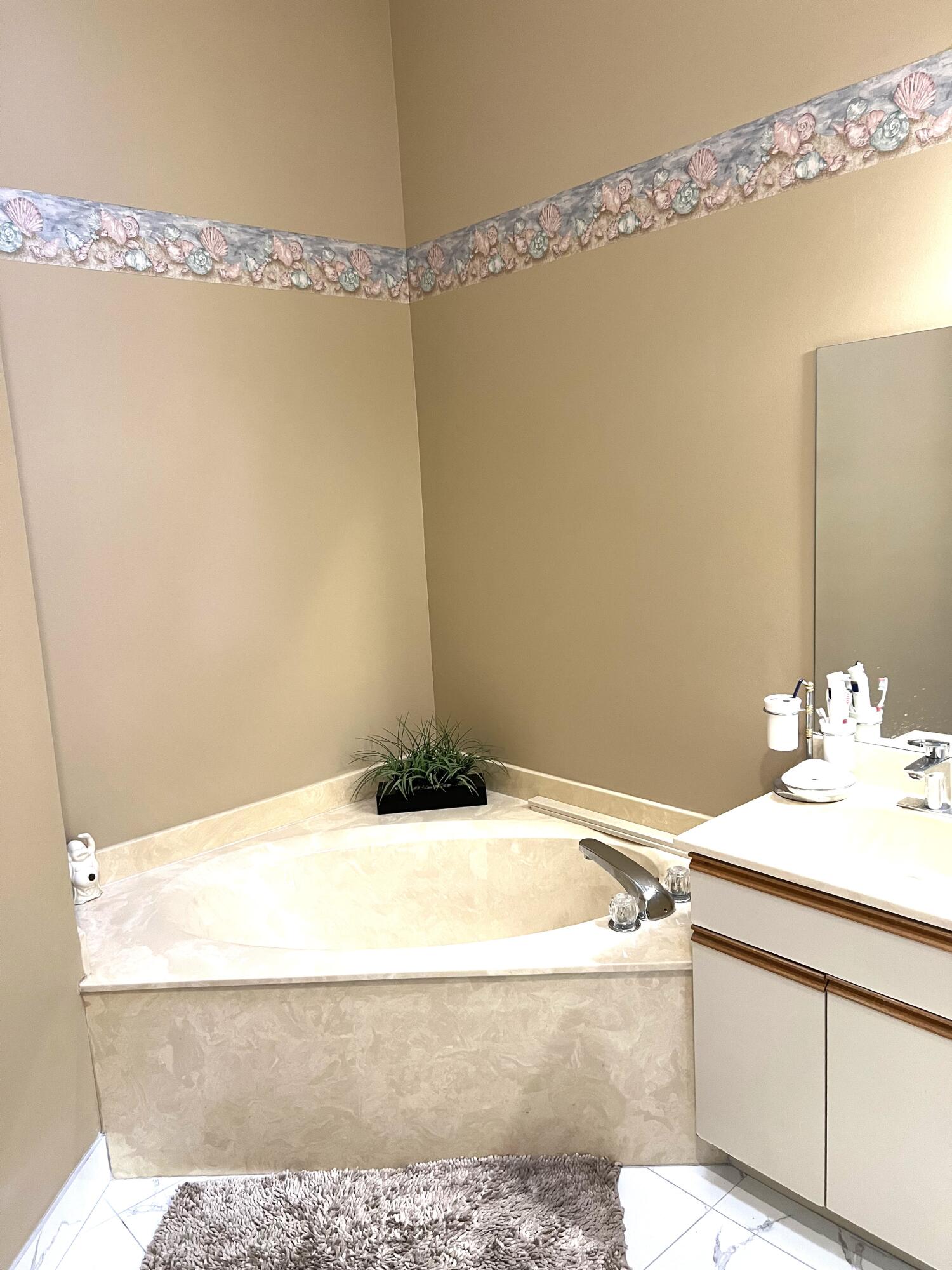 9416 Boca River Circle, Unit 9416 Boca Raton, FL 33434 - Photo 12 of 34 a bathroom with a sink and a mirror