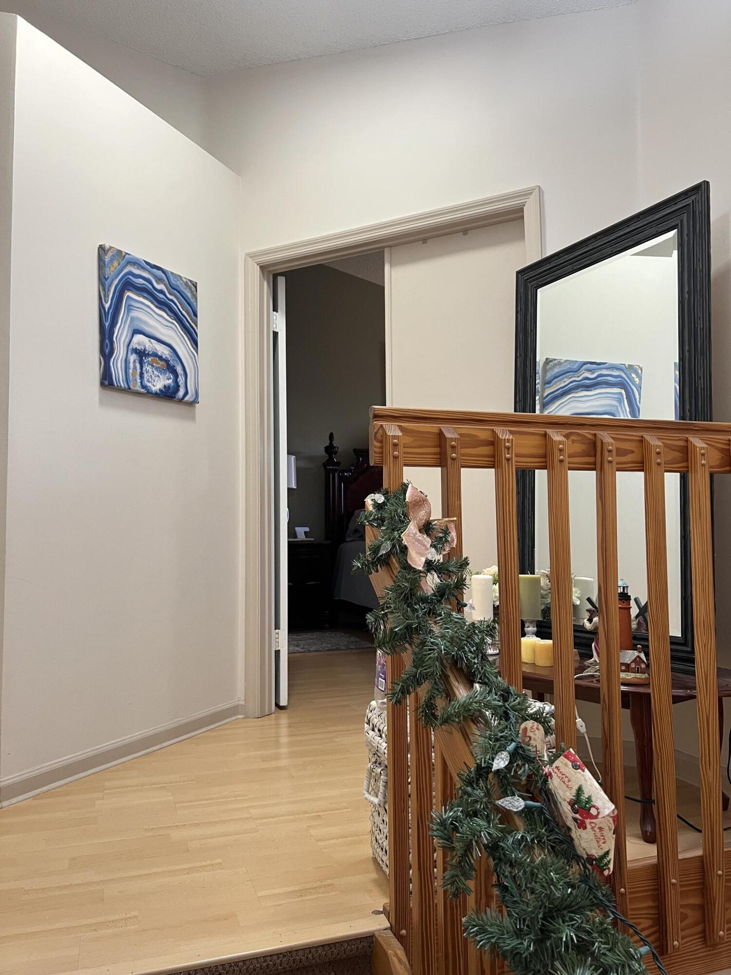 9416 Boca River Circle, Unit 9416 Boca Raton, FL 33434 - Photo 13 of 34 a view of a hallway with wooden floor