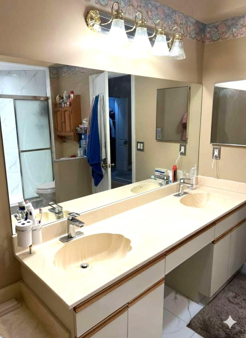 9416 Boca River Circle, Unit 9416 Boca Raton, FL 33434 - Photo 14 of 34 a bathroom with a sink vanity and a mirror