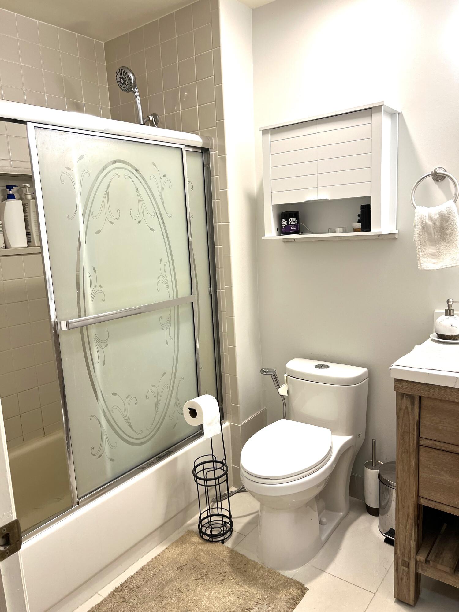 9416 Boca River Circle, Unit 9416 Boca Raton, FL 33434 - Photo 17 of 34 a bathroom with a toilet and a shower