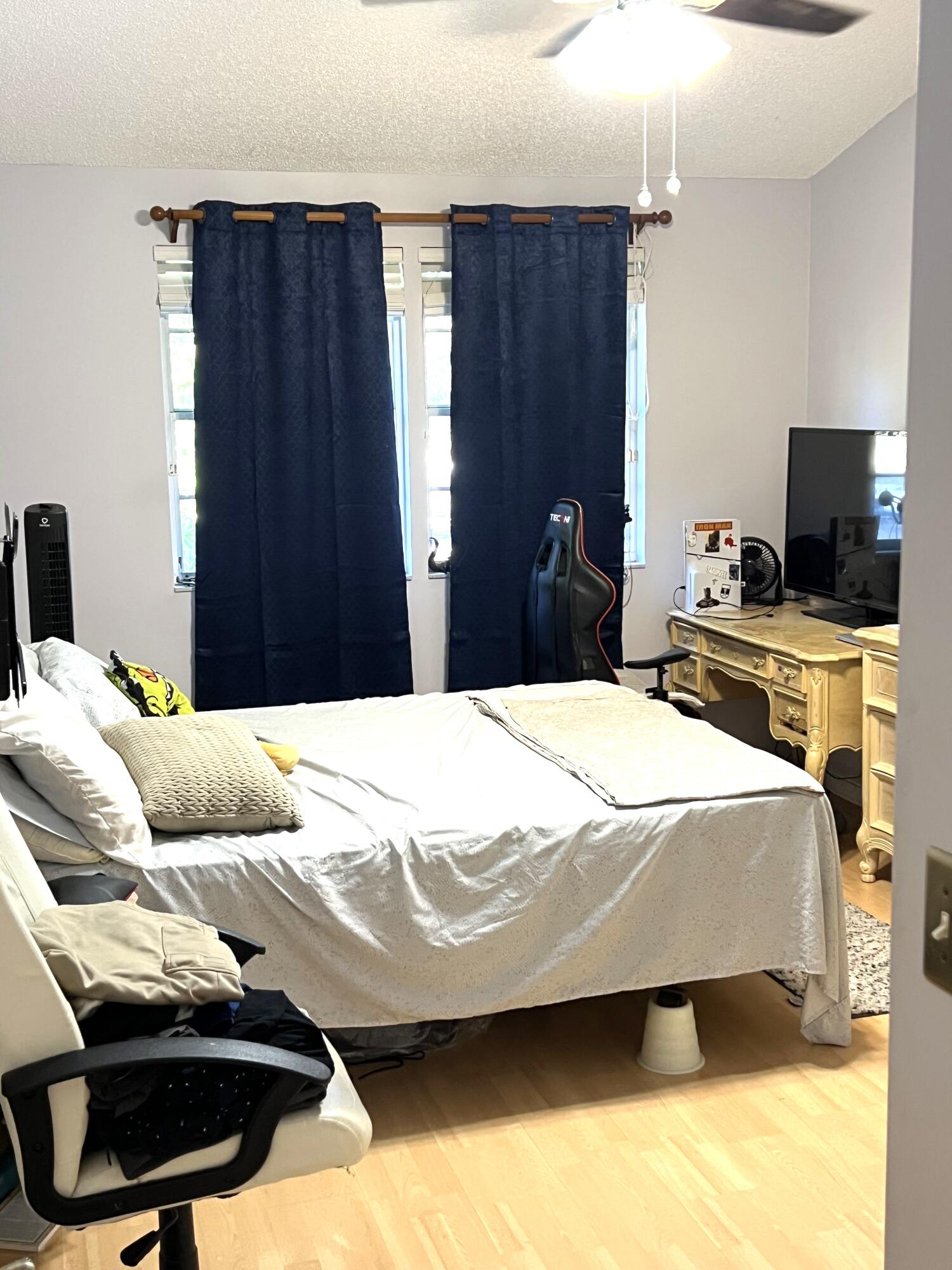 9416 Boca River Circle, Unit 9416 Boca Raton, FL 33434 - Photo 18 of 34 a bedroom with a bed and tv