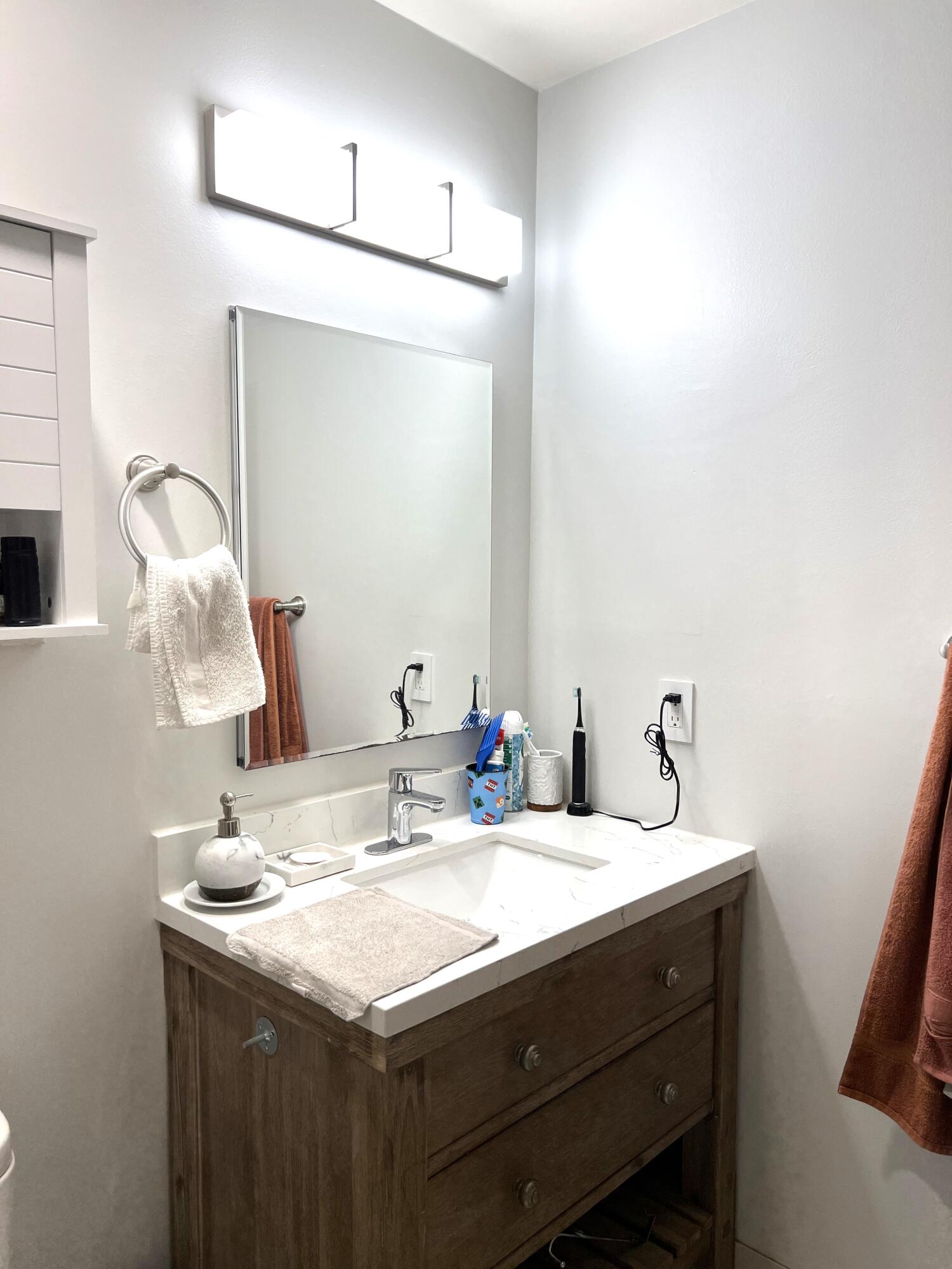 9416 Boca River Circle, Unit 9416 Boca Raton, FL 33434 - Photo 19 of 34 a bathroom with a sink and a mirror