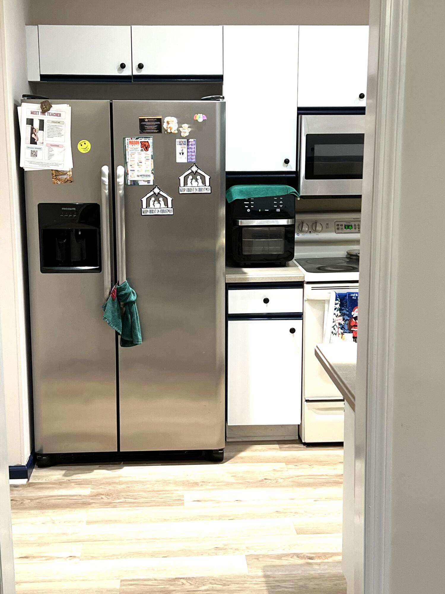 9416 Boca River Circle, Unit 9416 Boca Raton, FL 33434 - Photo 2 of 34 a view of a refrigerator in kitchen and an empty room
