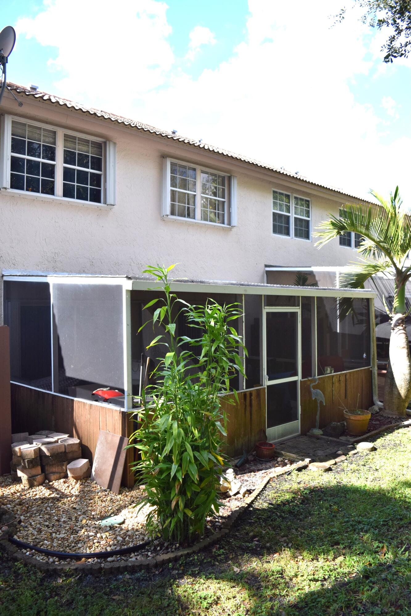 9416 Boca River Circle, Unit 9416 Boca Raton, FL 33434 - Photo 22 of 34 a front view of a house with a yard