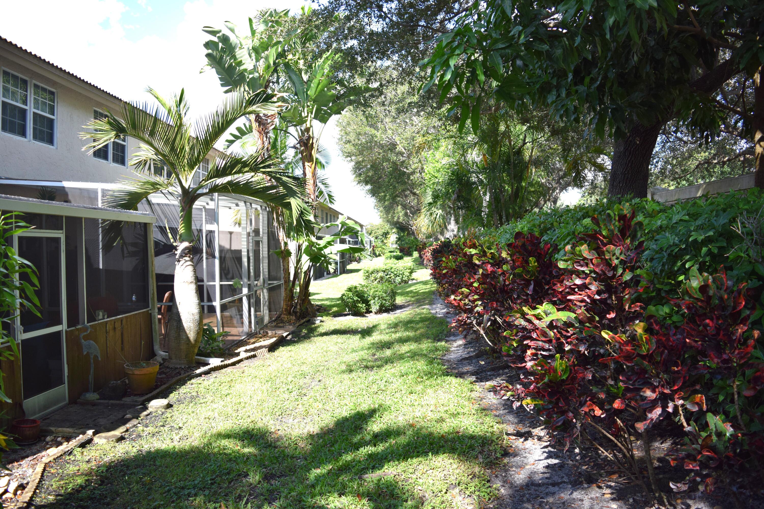 9416 Boca River Circle, Unit 9416 Boca Raton, FL 33434 - Photo 24 of 34 a view of a house with a tree in a yard