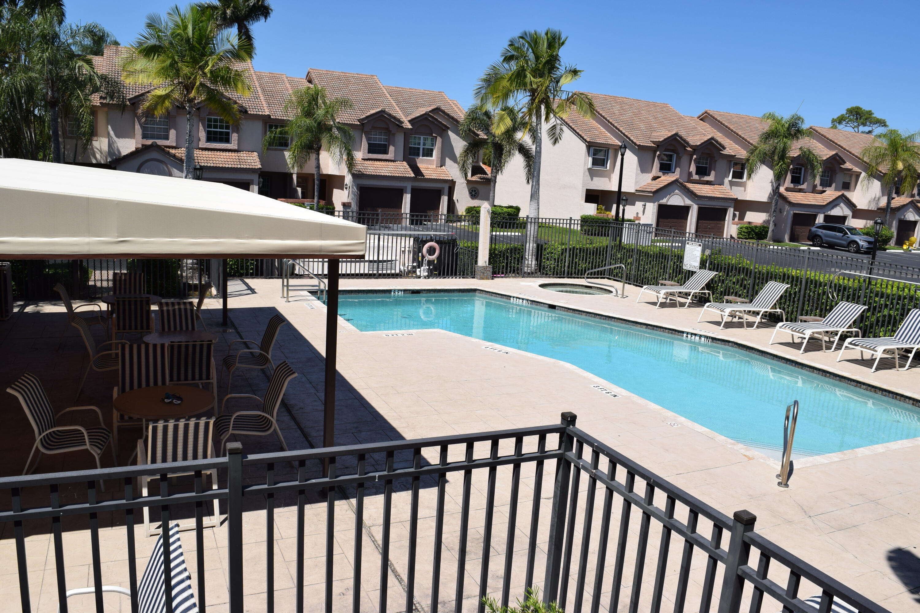 9416 Boca River Circle, Unit 9416 Boca Raton, FL 33434 - Photo 26 of 34 a view of a patio with swimming pool table and chairs