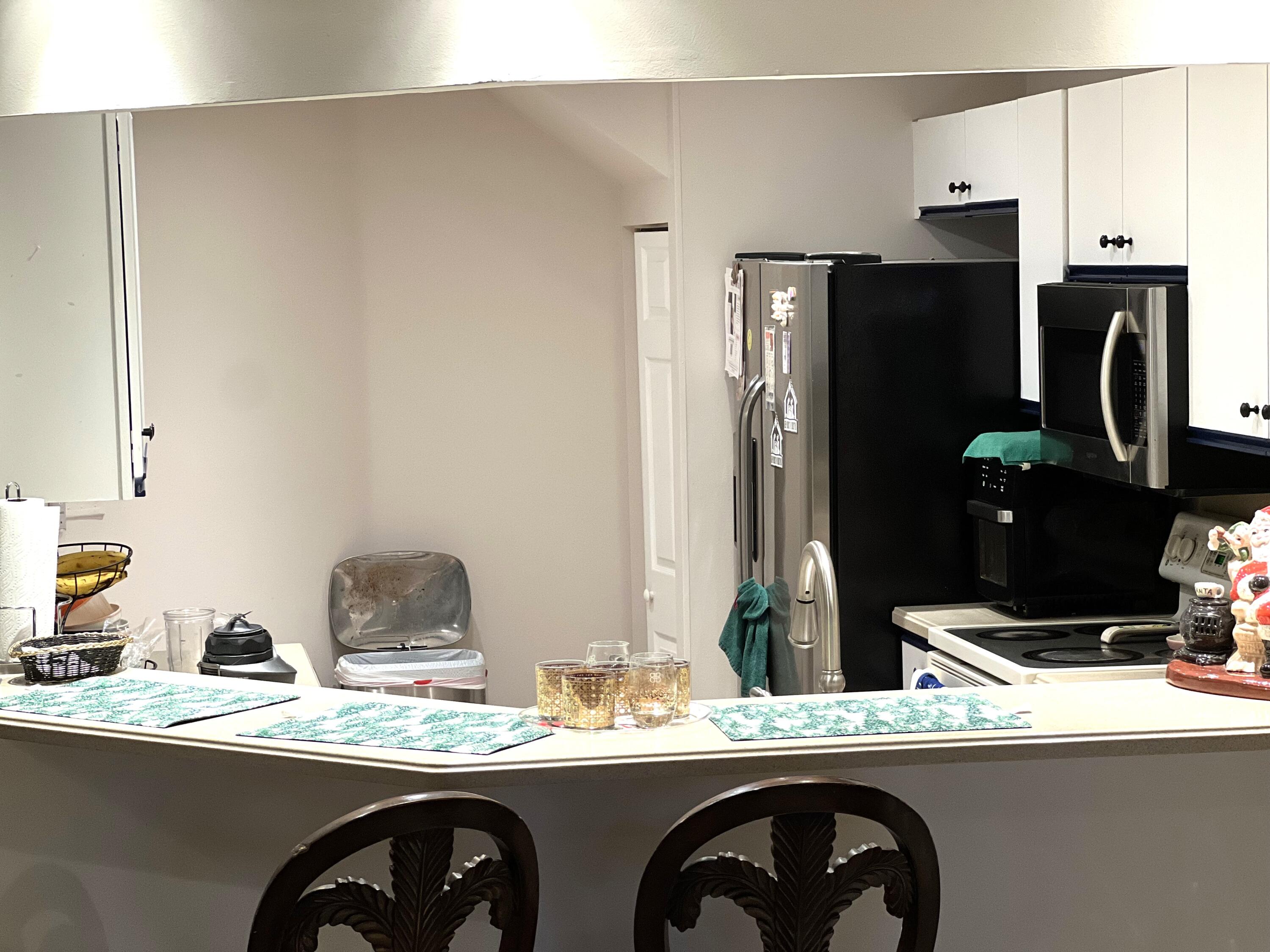 9416 Boca River Circle, Unit 9416 Boca Raton, FL 33434 - Photo 3 of 34 a kitchen with stainless steel appliances kitchen island a refrigerator sink and stove