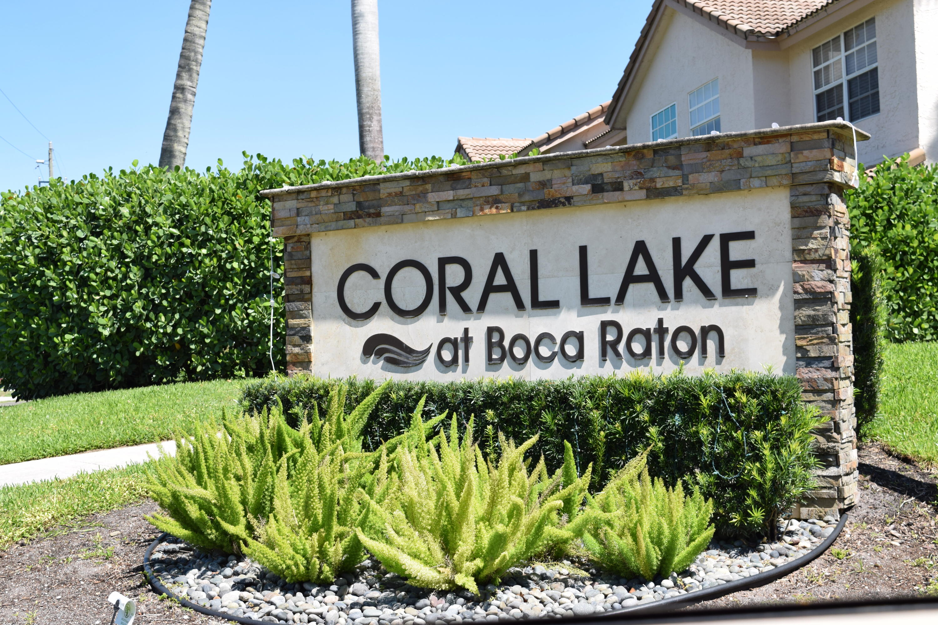 9416 Boca River Circle, Unit 9416 Boca Raton, FL 33434 - Photo 33 of 34 a sign on the side of a building