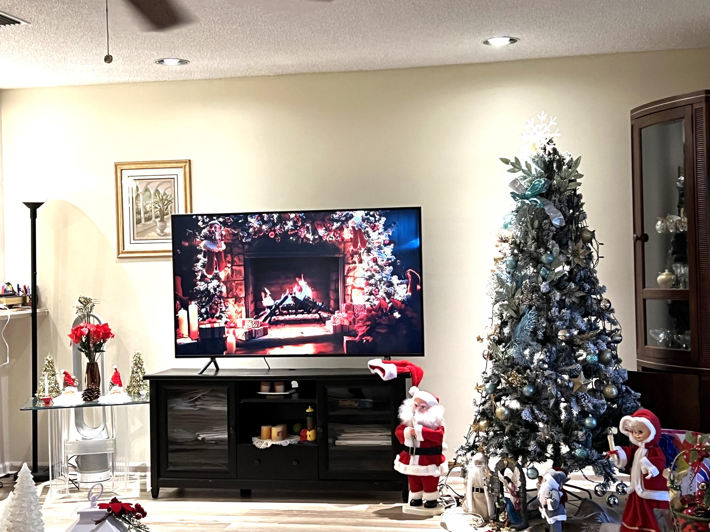 9416 Boca River Circle, Unit 9416 Boca Raton, FL 33434 - Photo 6 of 34 a room with red wall paintings a potted plant and a fireplace