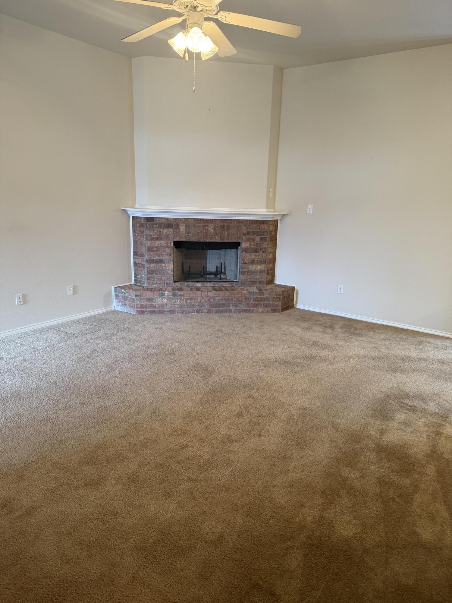 6544 84th Street Lubbock, TX 79424 - Photo 14 of 29 a view of empty room with a fireplace