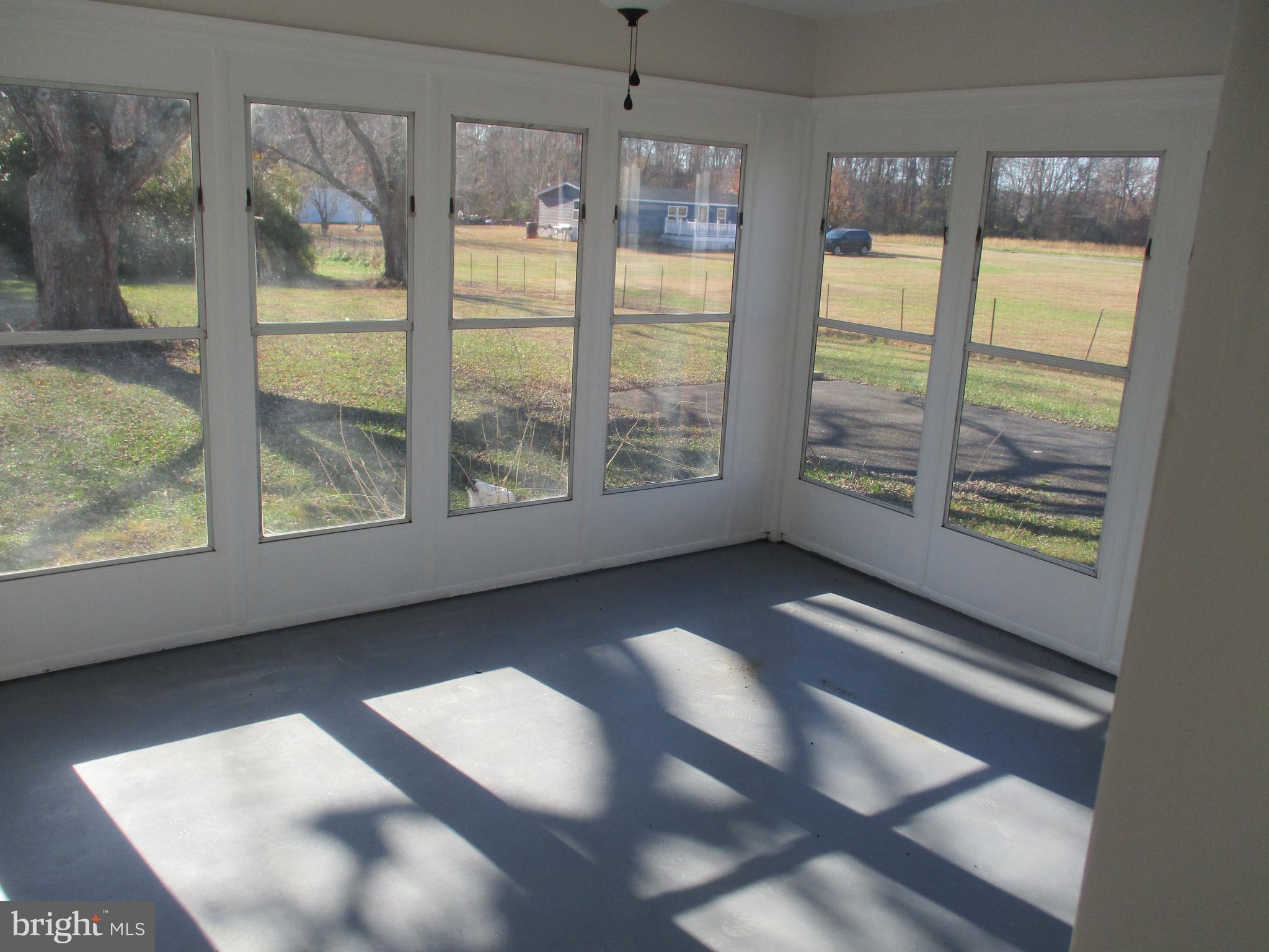 22403 Marsh Creek Road Preston, MD 21655 - Photo 13 of 35 a view of an empty room with wooden floor and a window