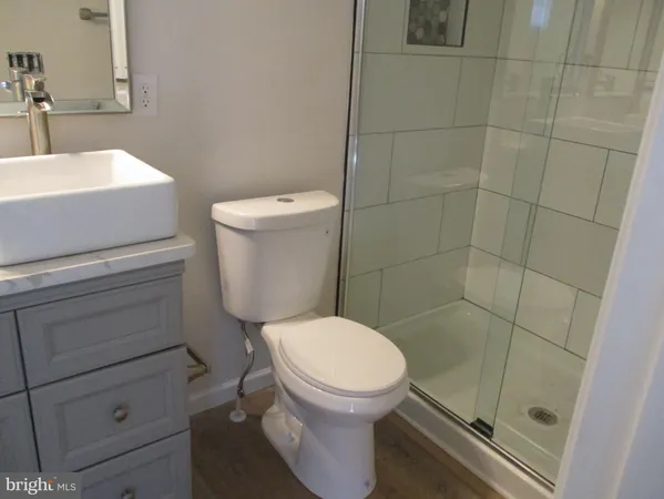 a white toilet sitting next to a bathroom sink