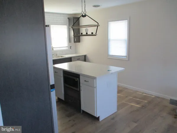 a kitchen with a sink cabinets and a window