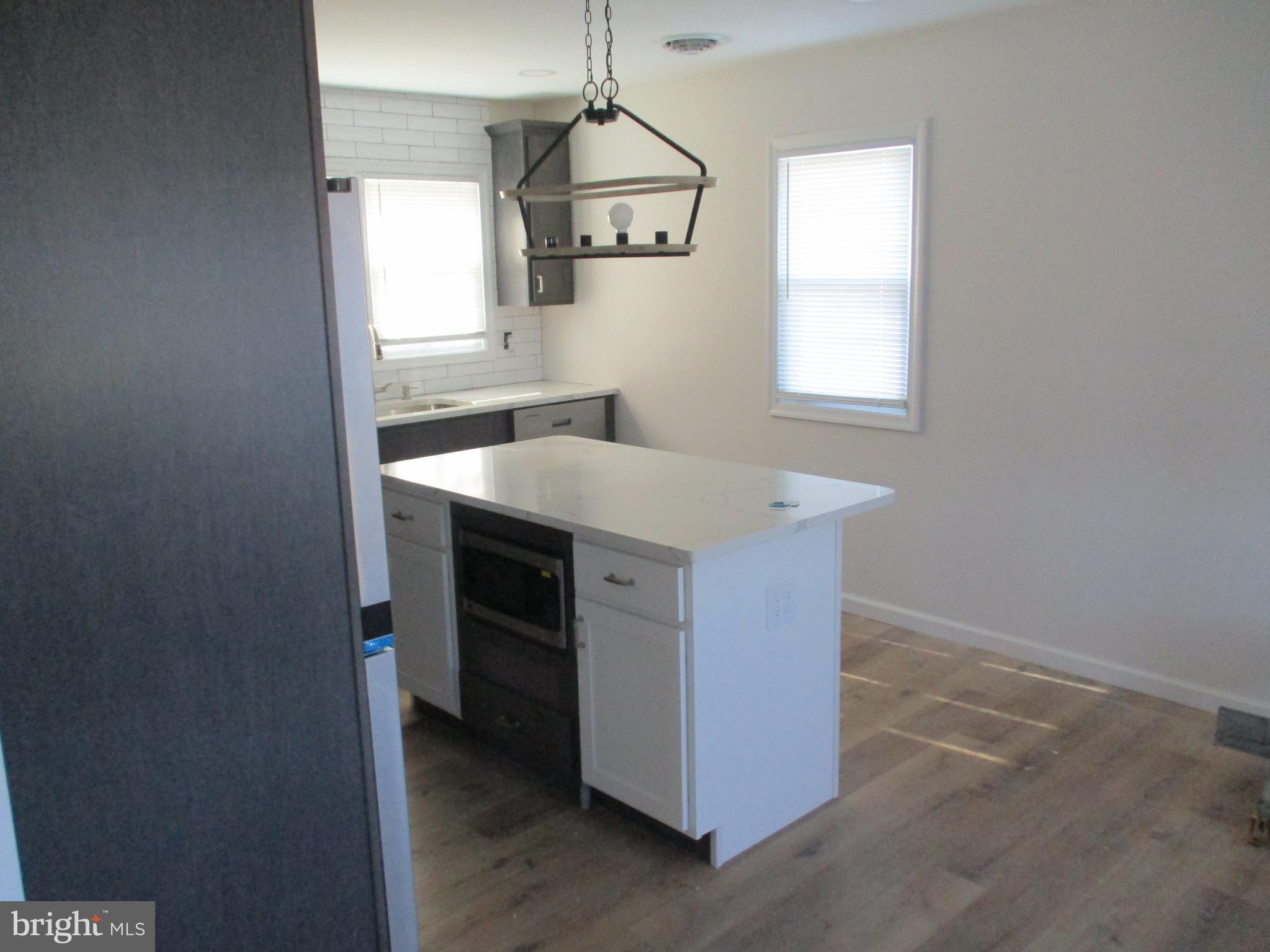 22403 Marsh Creek Road Preston, MD 21655 - Photo 19 of 35 a kitchen with a sink cabinets and a window