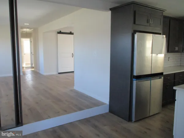 an empty room with wooden floor and a window