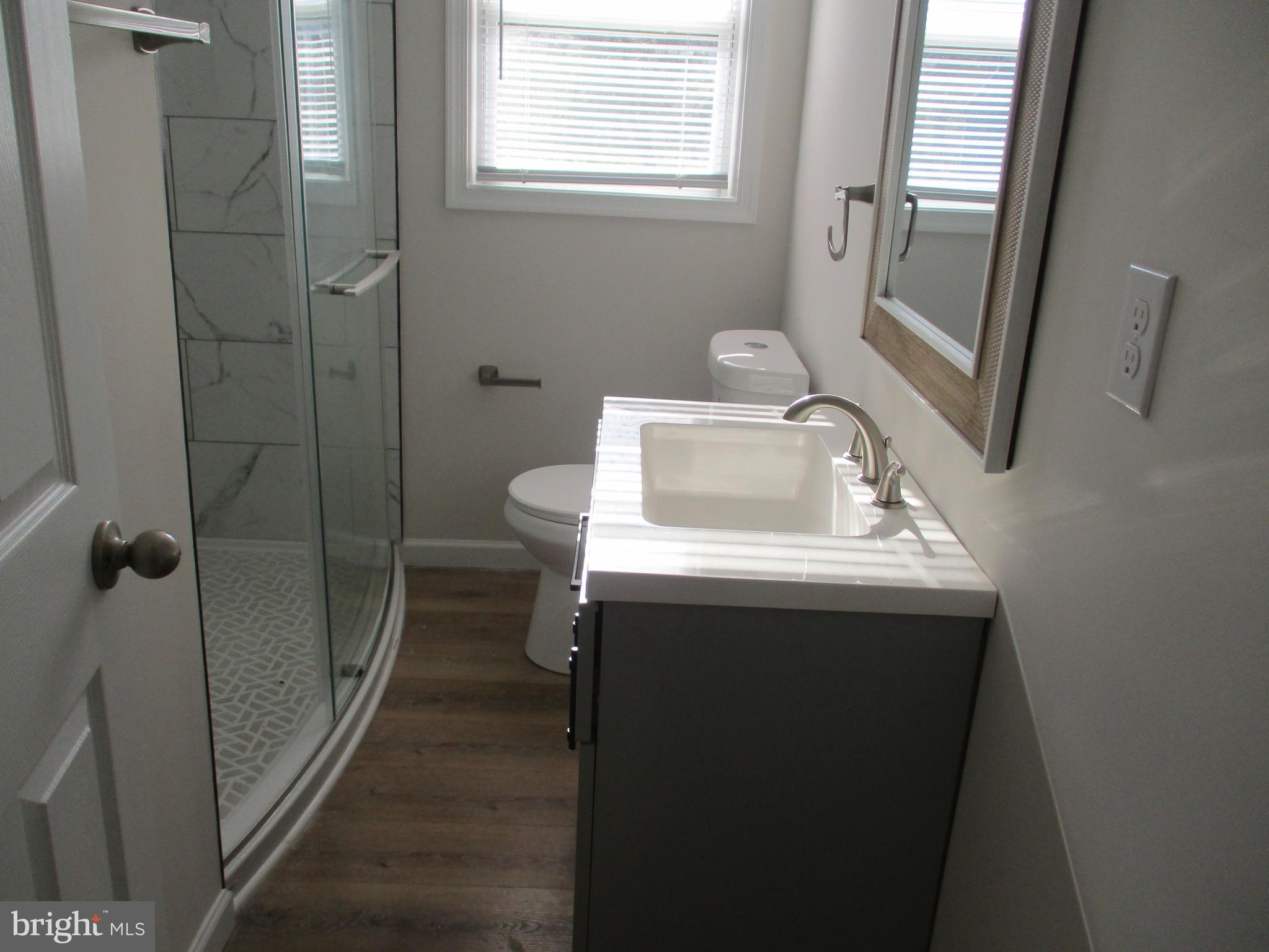 22403 Marsh Creek Road Preston, MD 21655 - Photo 22 of 35 a bathroom with a sink toilet and shower