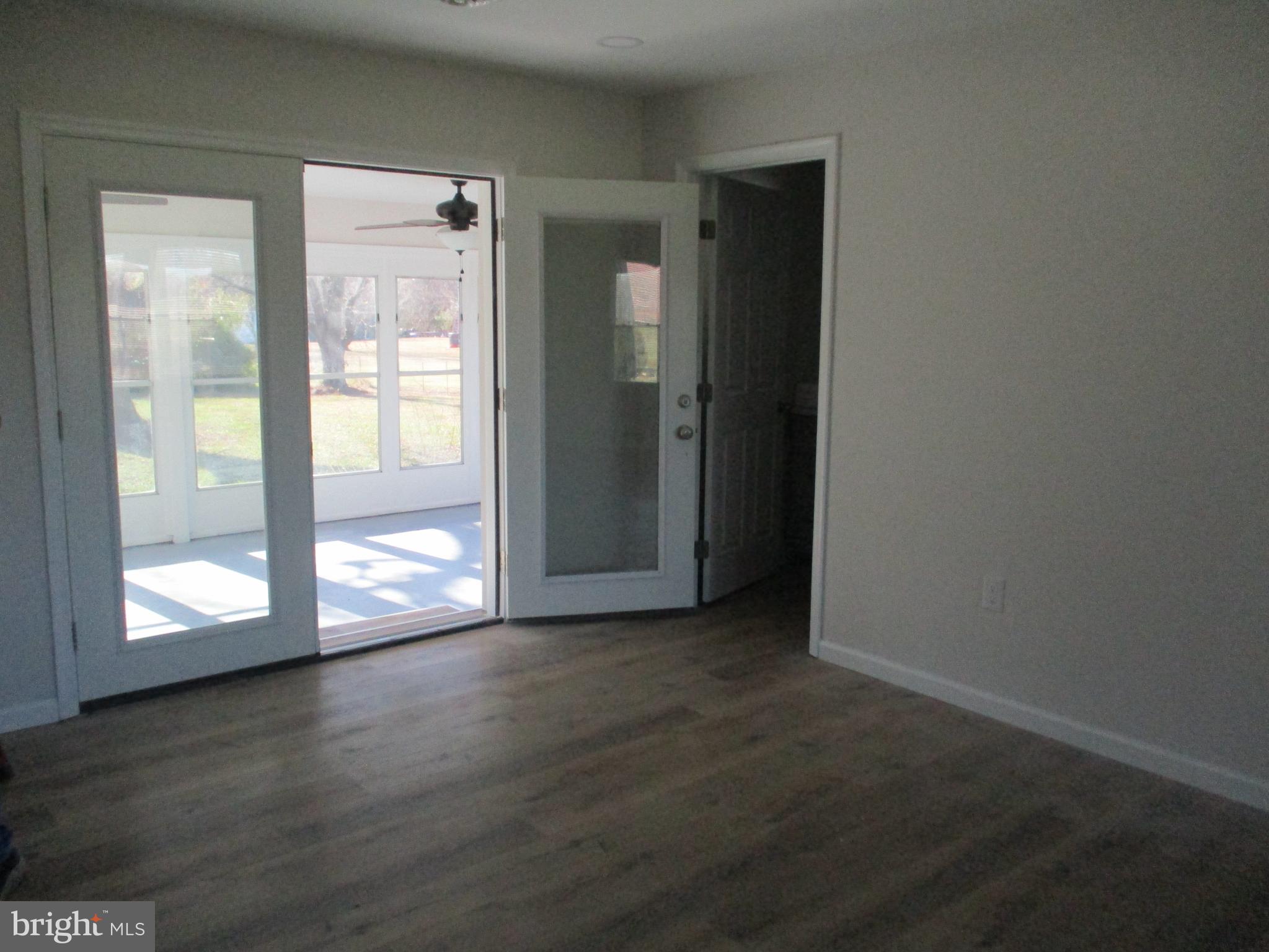 22403 Marsh Creek Road Preston, MD 21655 - Photo 33 of 35 an empty room with wooden floor and windows
