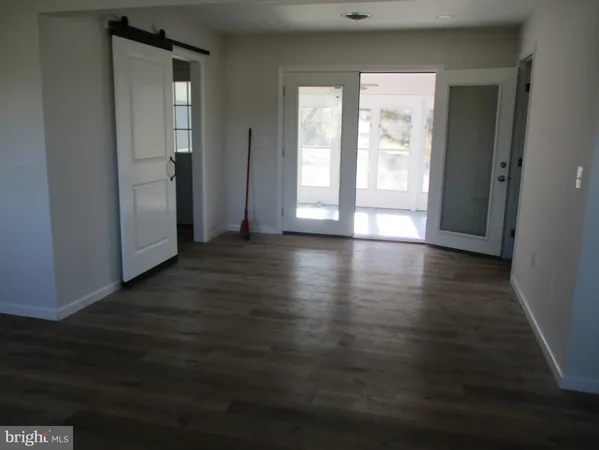 a view of wooden floor and windows in a room