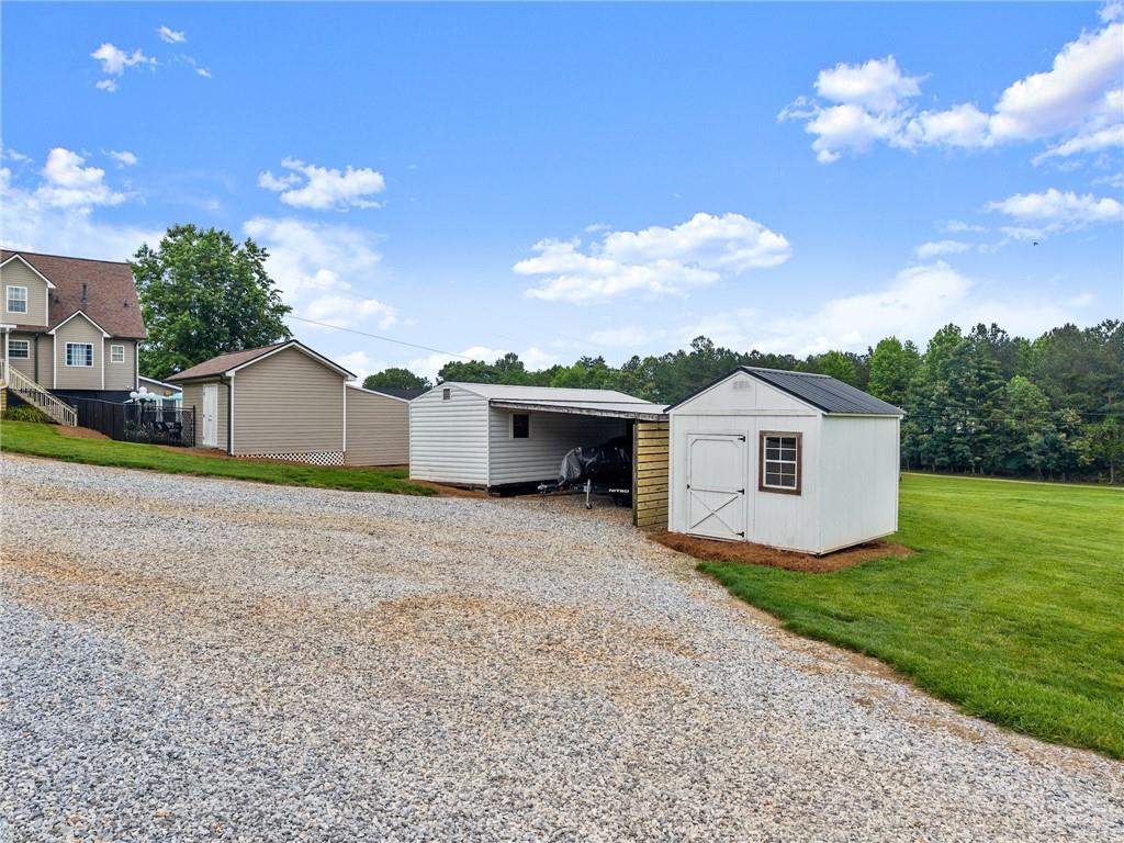 8958 Bill Savage Road Lula, GA 30554 - Photo 11 of 81 a view of a house with a yard and large tree