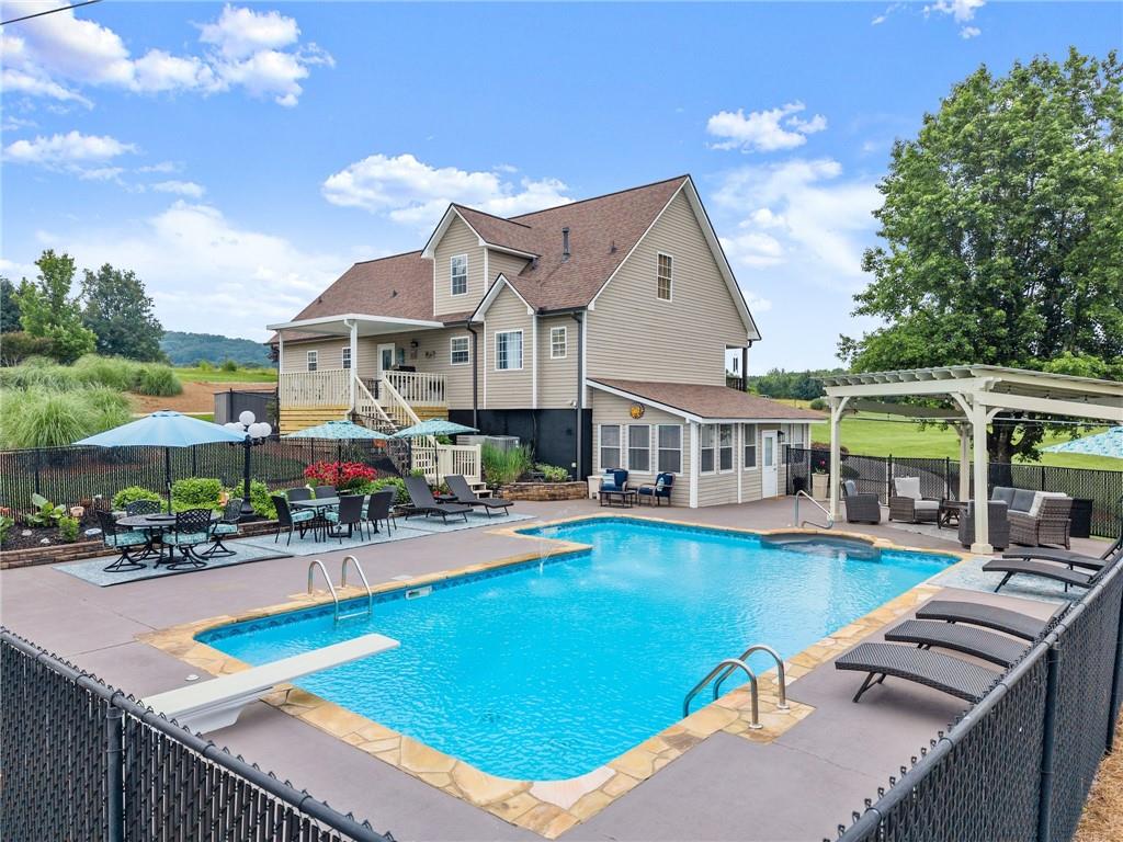 8958 Bill Savage Road Lula, GA 30554 - Photo 12 of 81 a view of a house with swimming pool and sitting area