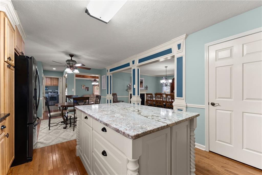 8958 Bill Savage Road Lula, GA 30554 - Photo 18 of 81 a view of living room with granite countertop furniture and wooden floor