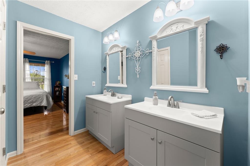 8958 Bill Savage Road Lula, GA 30554 - Photo 32 of 81 a en suite bathroom with a double vanity sink and a mirror
