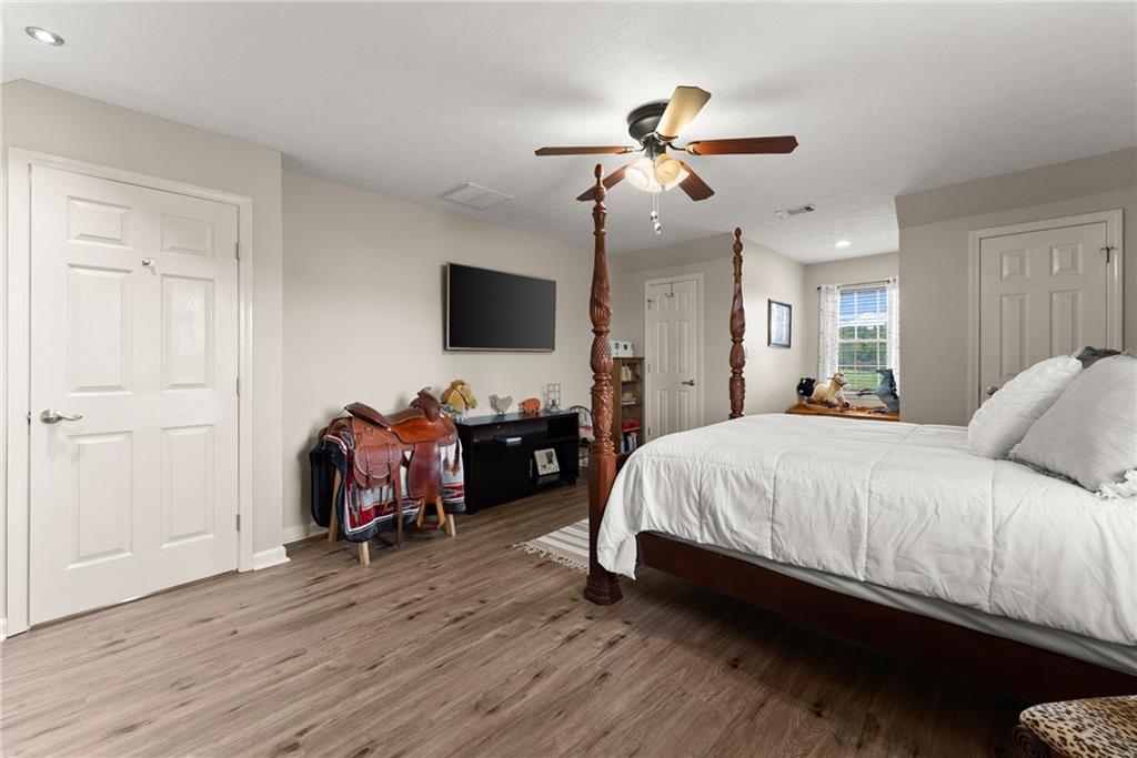 8958 Bill Savage Road Lula, GA 30554 - Photo 34 of 81 a bed room with a bed and a flat screen tv