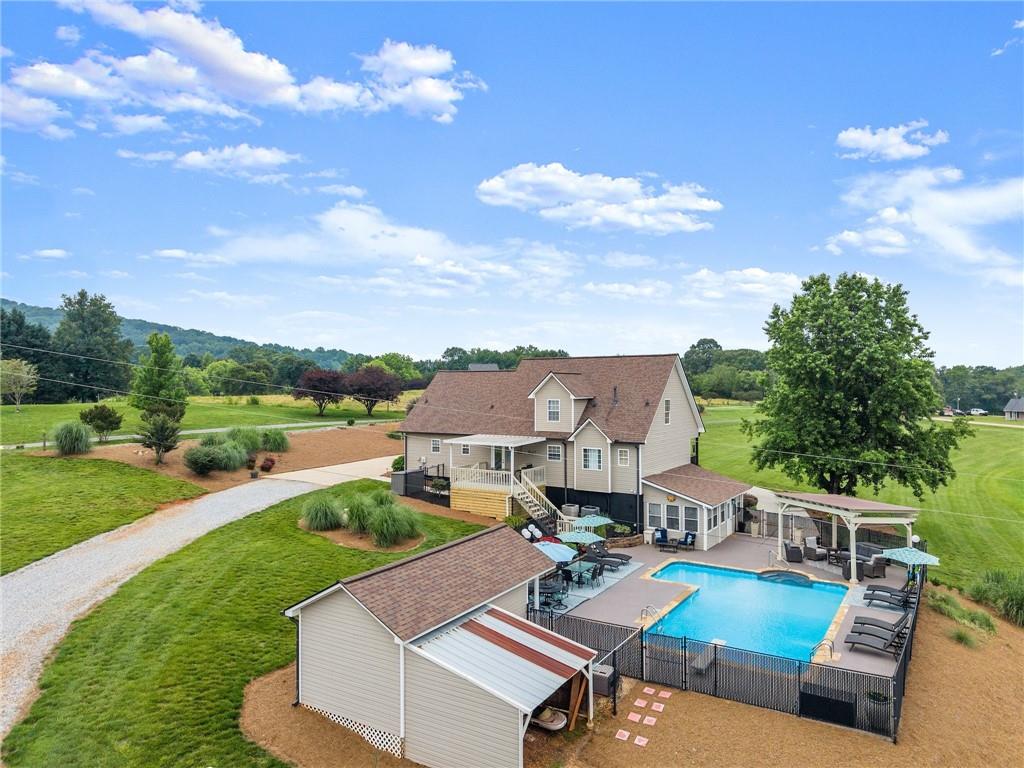 8958 Bill Savage Road Lula, GA 30554 - Photo 4 of 81 a view of a house with pool and chairs