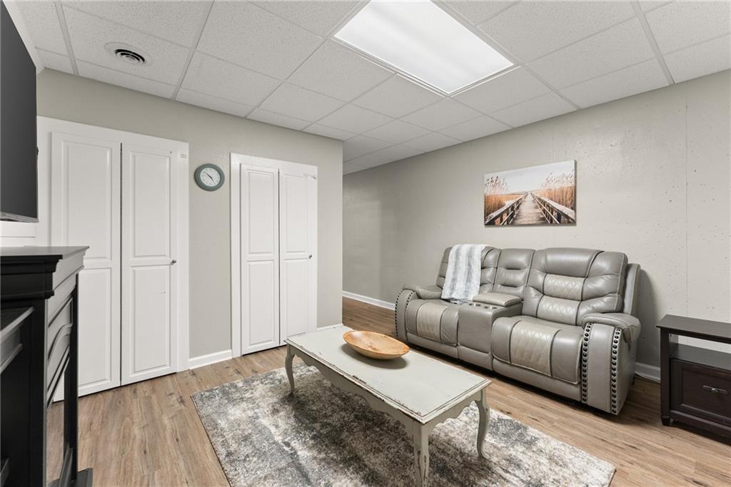 8958 Bill Savage Road Lula, GA 30554 - Photo 44 of 81 a living room with furniture and wooden floor