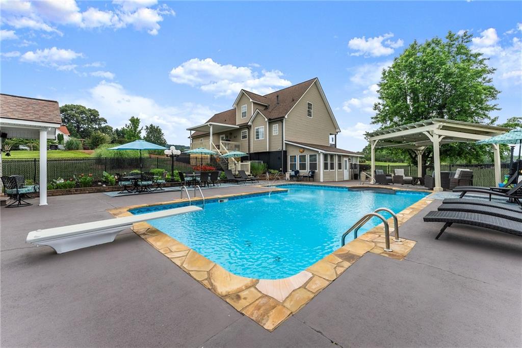 8958 Bill Savage Road Lula, GA 30554 - Photo 58 of 81 a view of a house with swimming pool and sitting area