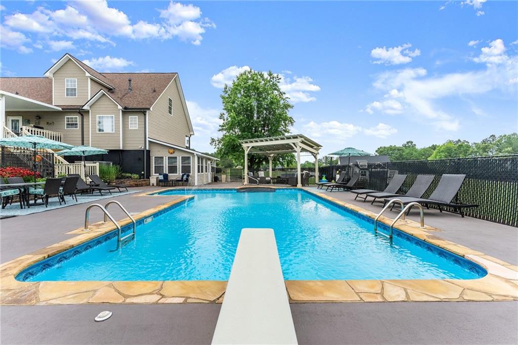 8958 Bill Savage Road Lula, GA 30554 - Photo 59 of 81 a view of a house with swimming pool and sitting area