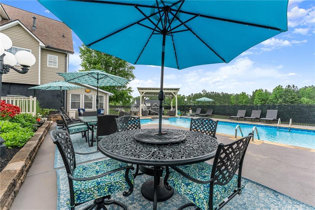 8958 Bill Savage Road Lula, GA 30554 - Photo 61 of 81 a view of a patio with furniture and a yard