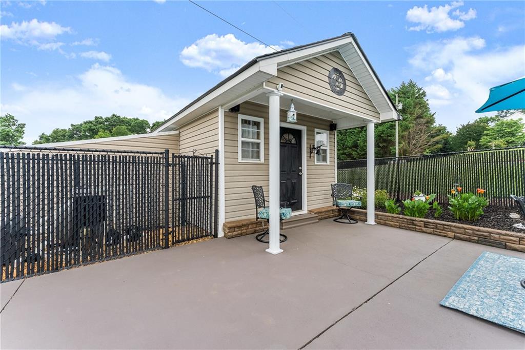 8958 Bill Savage Road Lula, GA 30554 - Photo 63 of 81 a backyard of a house with lake view and a floor to ceiling window