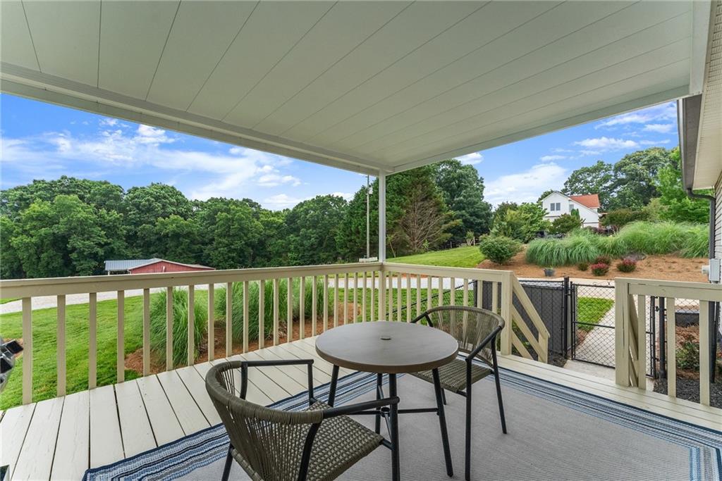 8958 Bill Savage Road Lula, GA 30554 - Photo 68 of 81 a view of balcony with furniture and wooden deck