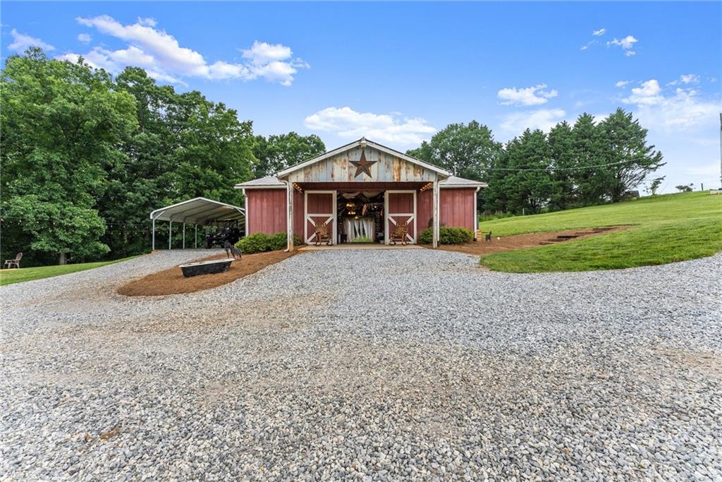8958 Bill Savage Road Lula, GA 30554 - Photo 71 of 81 a view of a house with a yard and large tree