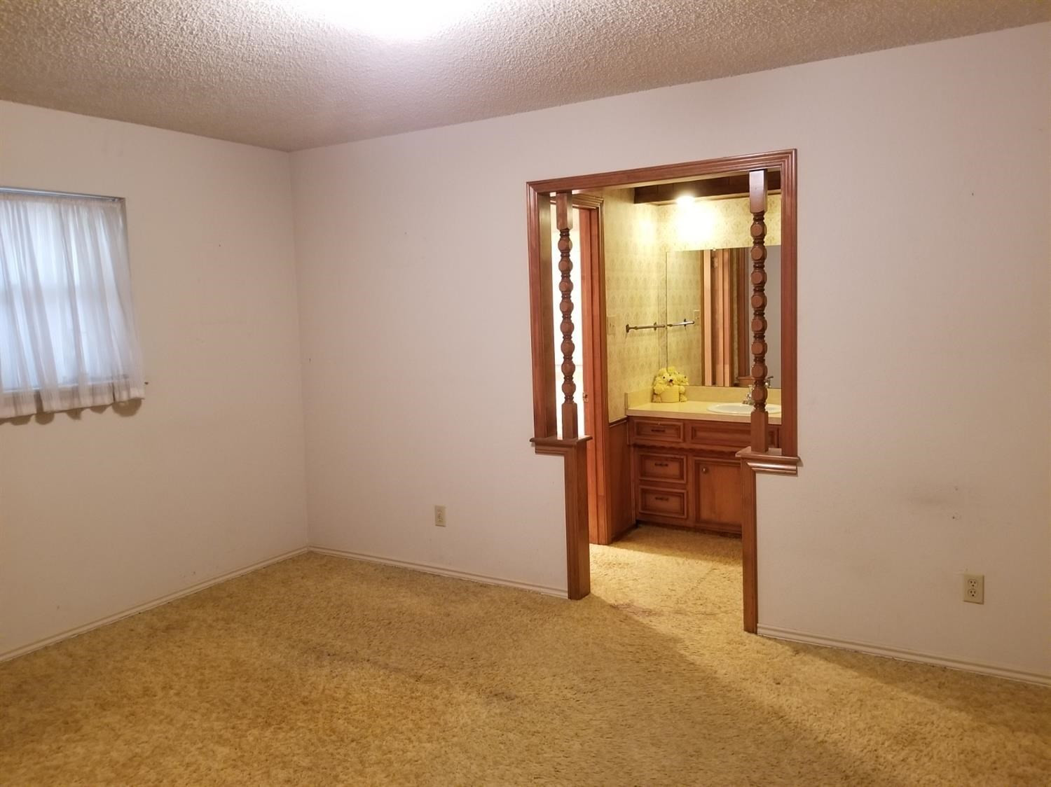 5314 22nd Street Lubbock, TX 79407 - Photo 3 of 10 an empty room with a window and closet
