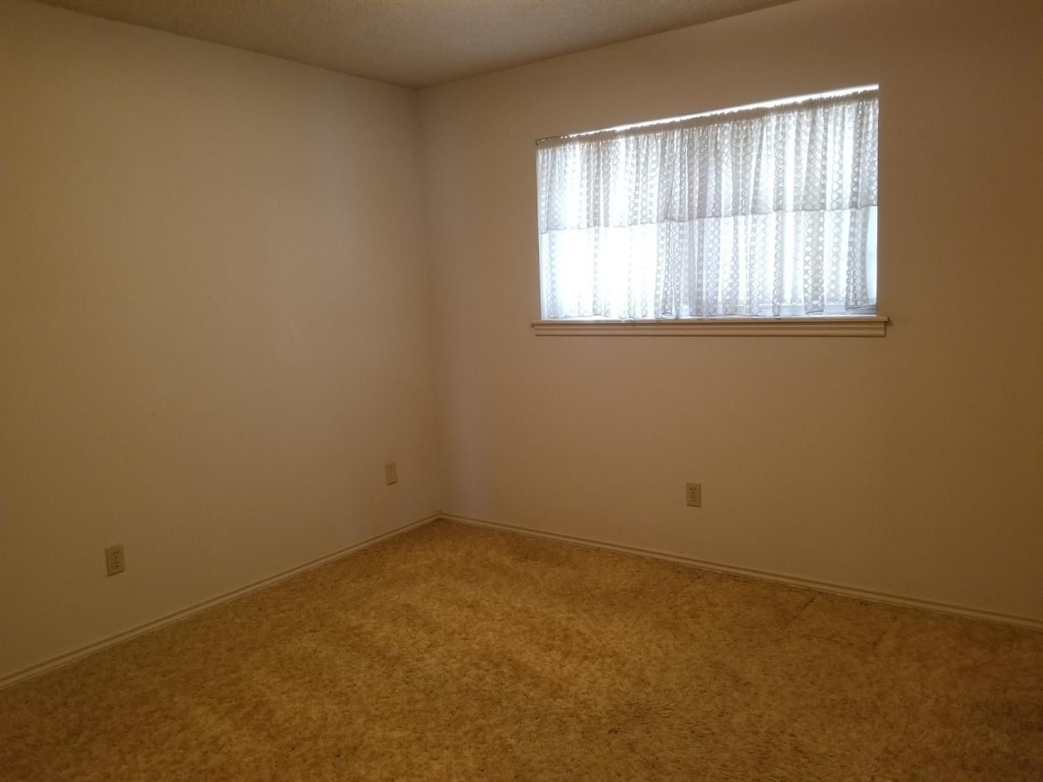5314 22nd Street Lubbock, TX 79407 - Photo 8 of 10 an empty room with a window